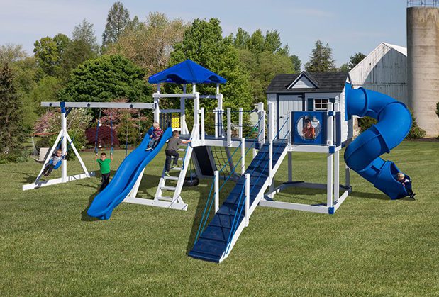 Children playing on a white and blue swing set.